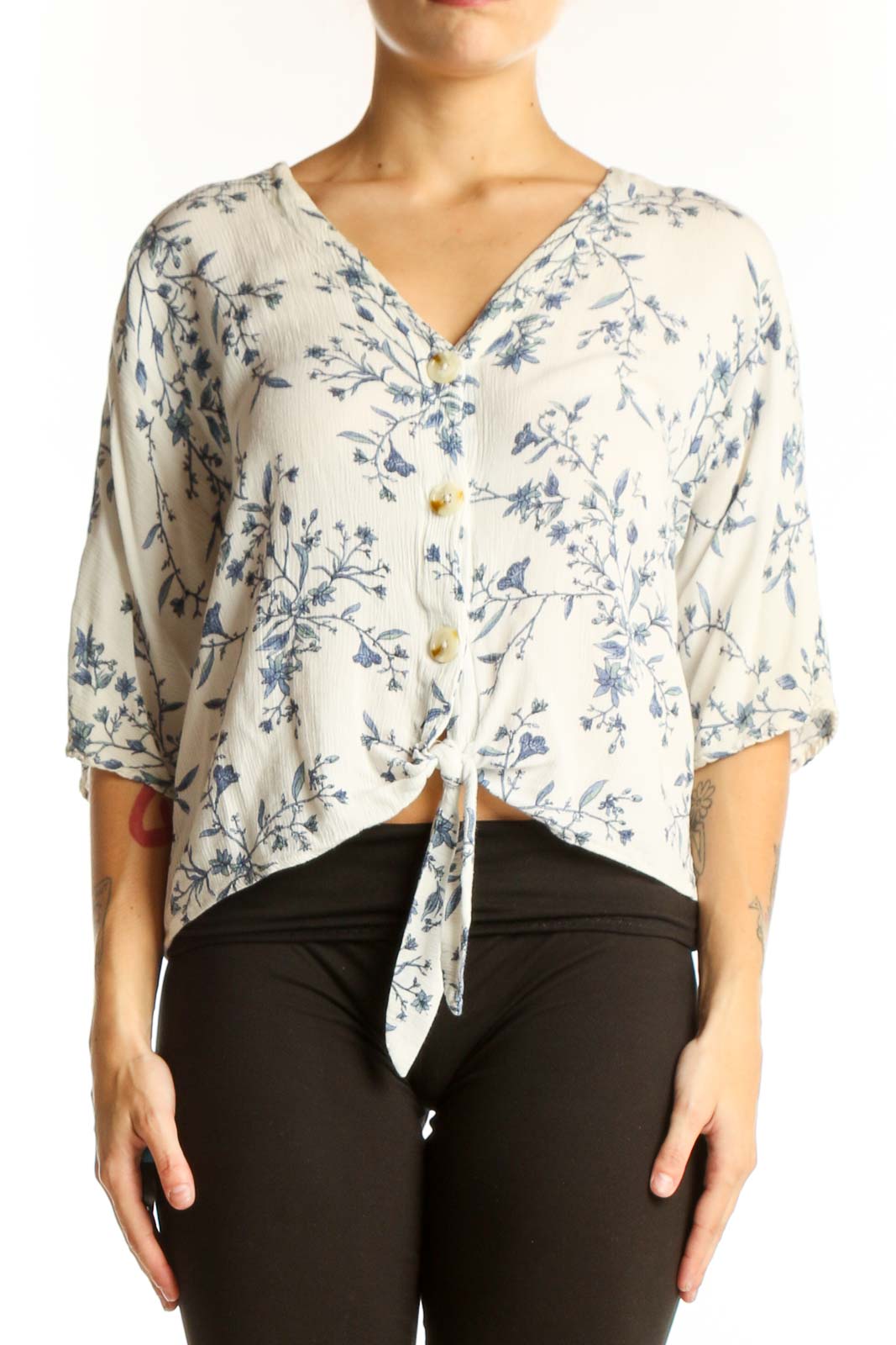 Front view of white Luq blouse with blue floral print and tie-front detail