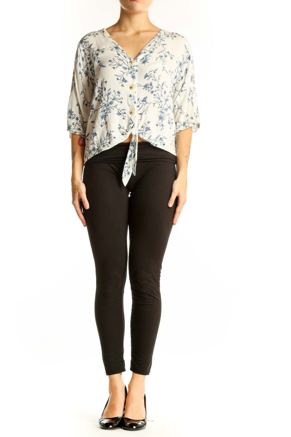 Front view of white Luq blouse with blue floral print and tie-front detail