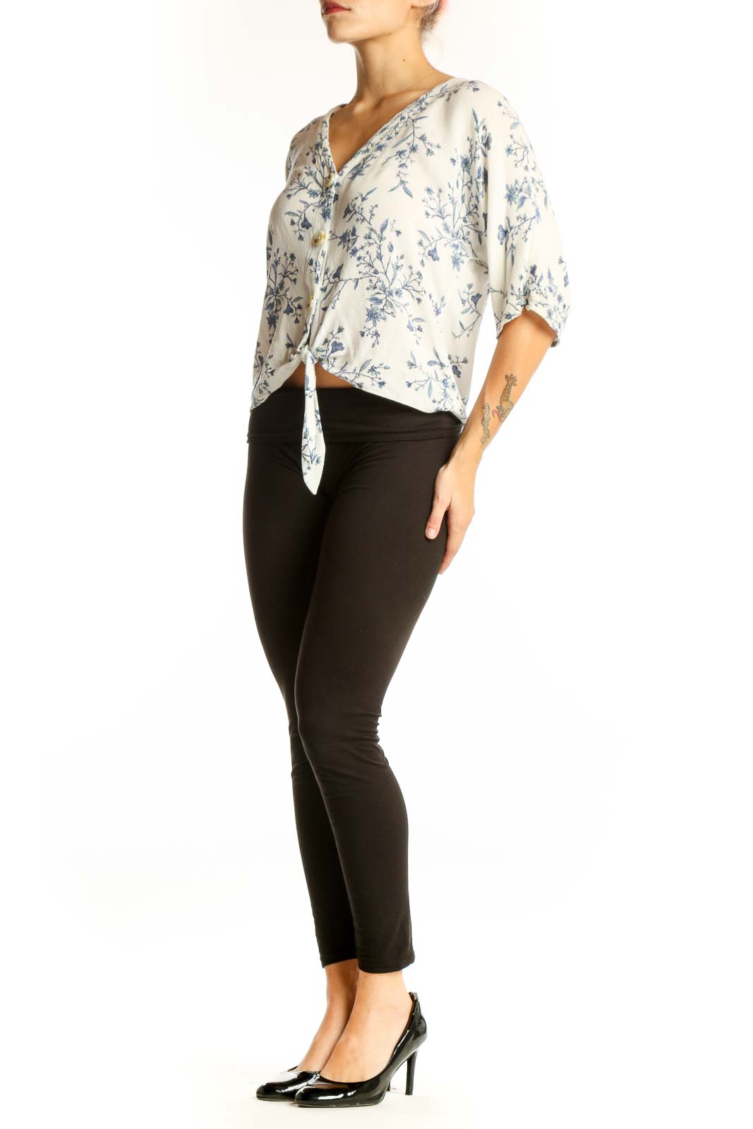 Front view of white Luq blouse with blue floral print and tie-front detail