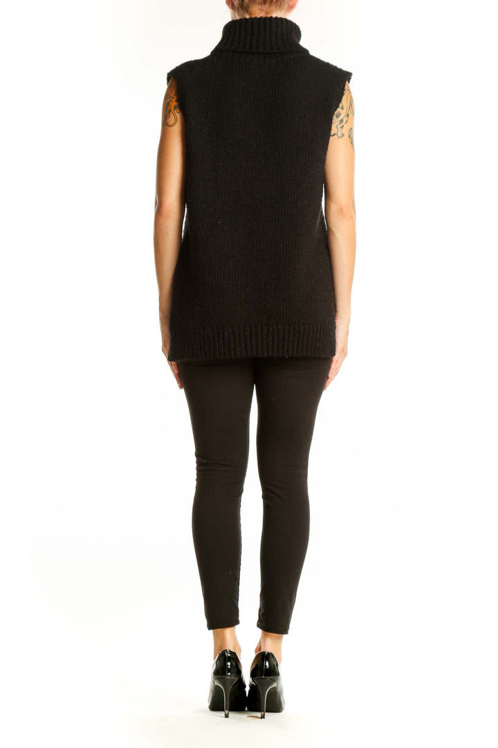Back view of black sleeveless turtleneck sweater by SilkRoll on model