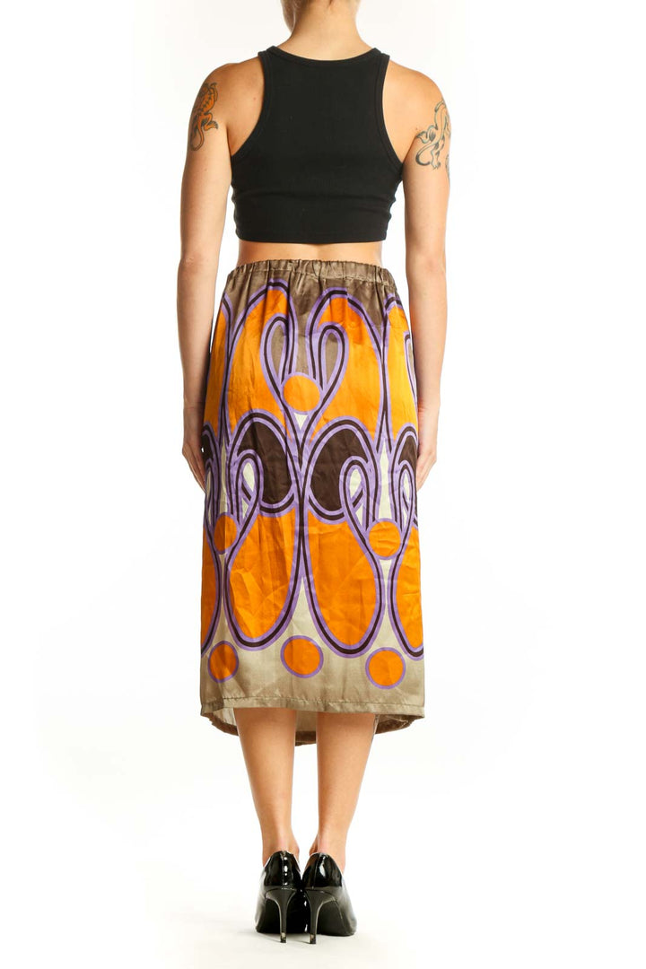 Back view of SilkRoll orange and purple abstract print silk midi skirt on model