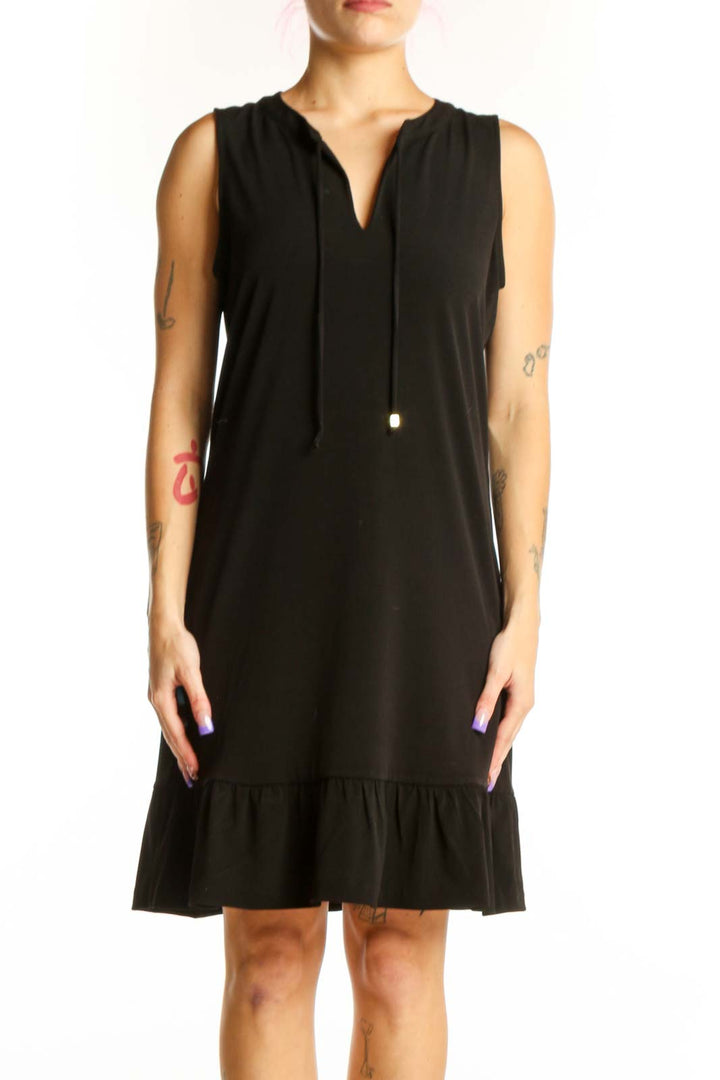 Black sleeveless shift dress with V-neckline and ruffle hem, front view