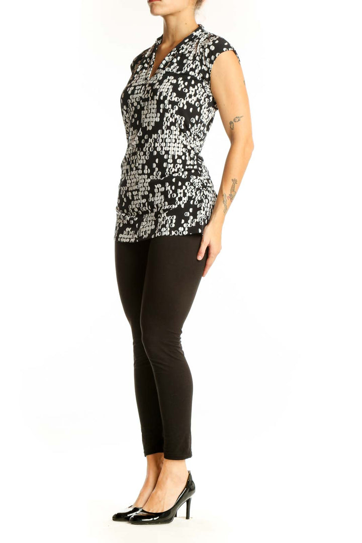 Front view of Vince Camuto black and white geometric print sleeveless top
