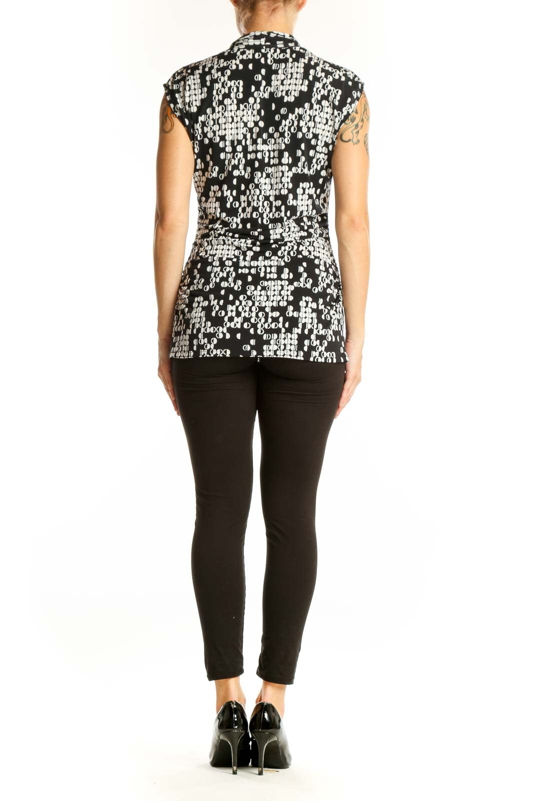 Side view of model wearing Vince Camuto black and white geometric print sleeveless top