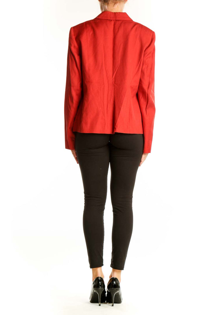 Side view of red Anne Klein blazer jacket on model with black pants