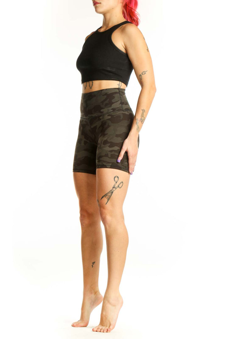 Front view of olive camo Lululemon bike shorts XS with high-waisted fitted design and camouflage pattern