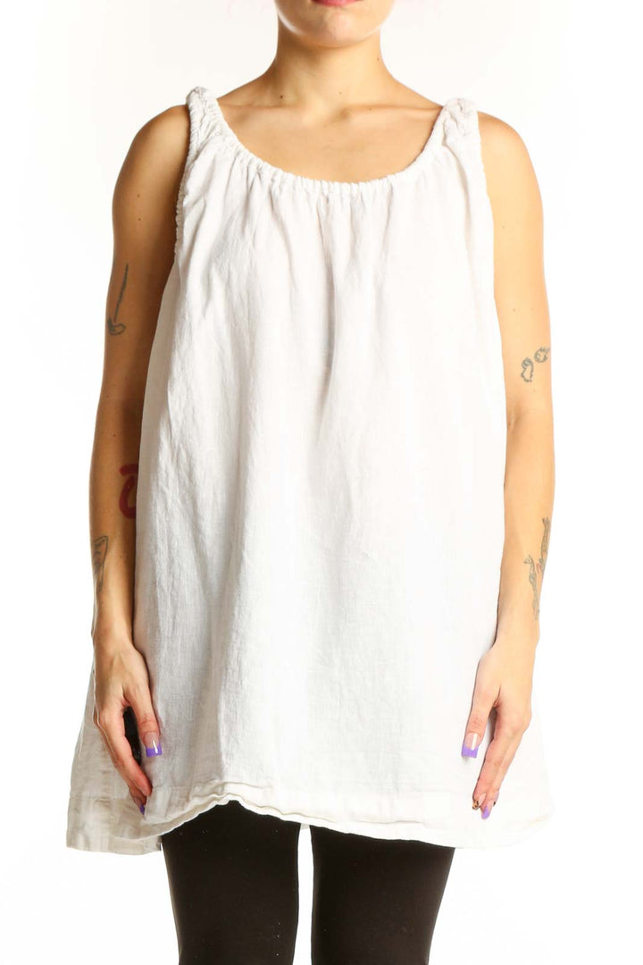 White linen cotton tank top with gathered neckline and shoulder ties, displayed on model from front
