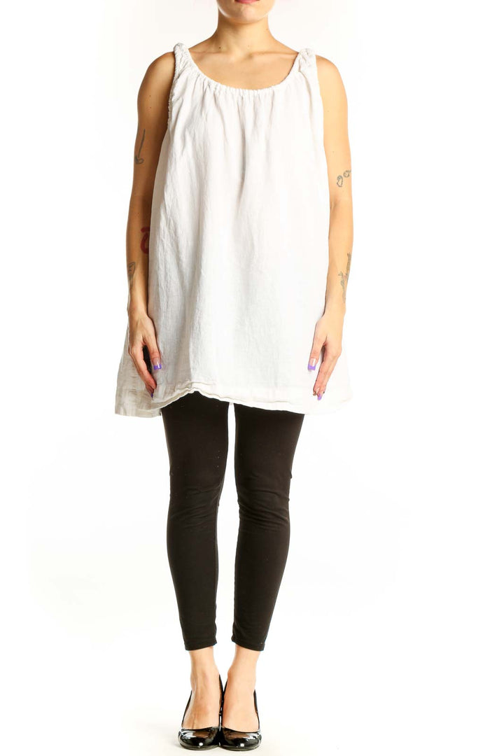 White linen cotton tank top with gathered neckline and shoulder ties, displayed on model from front