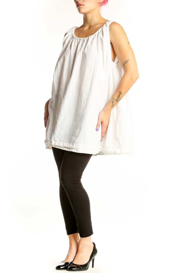 White linen cotton tank top with gathered neckline and shoulder ties, displayed on model from front