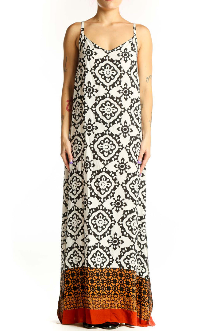Cream and black geometric print Vince Camuto maxi dress with burnt orange and red color-block hem, front view