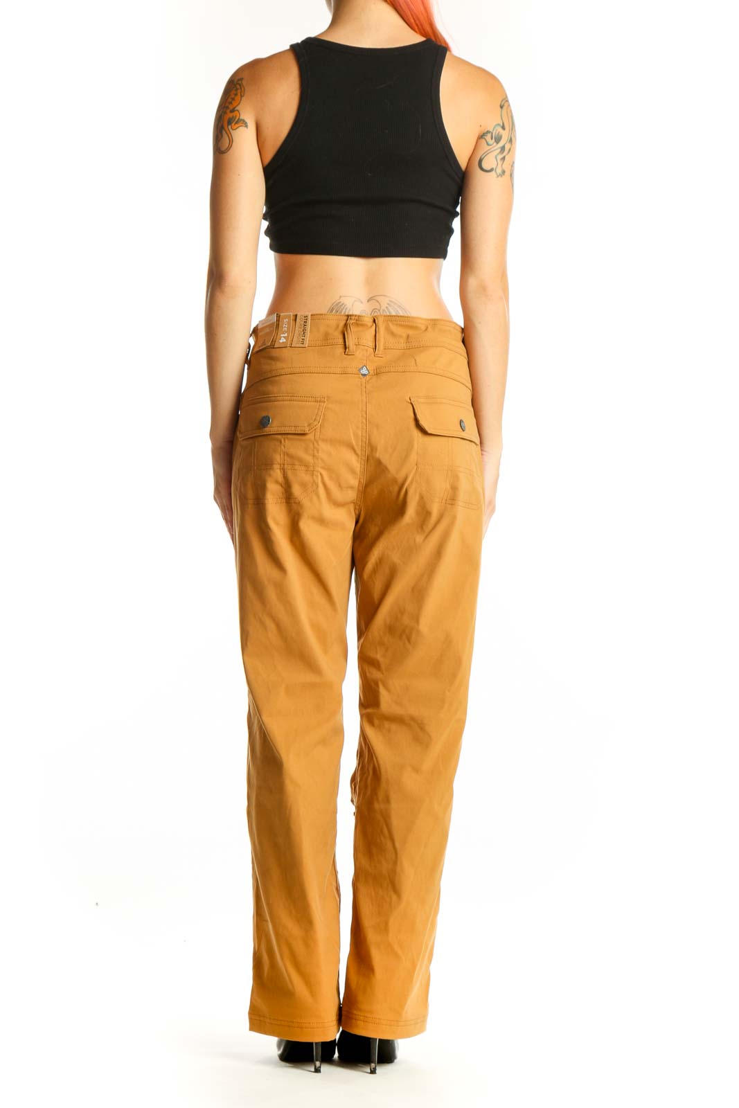Side view of prAna mustard straight-leg outdoor pants on model with black crop top