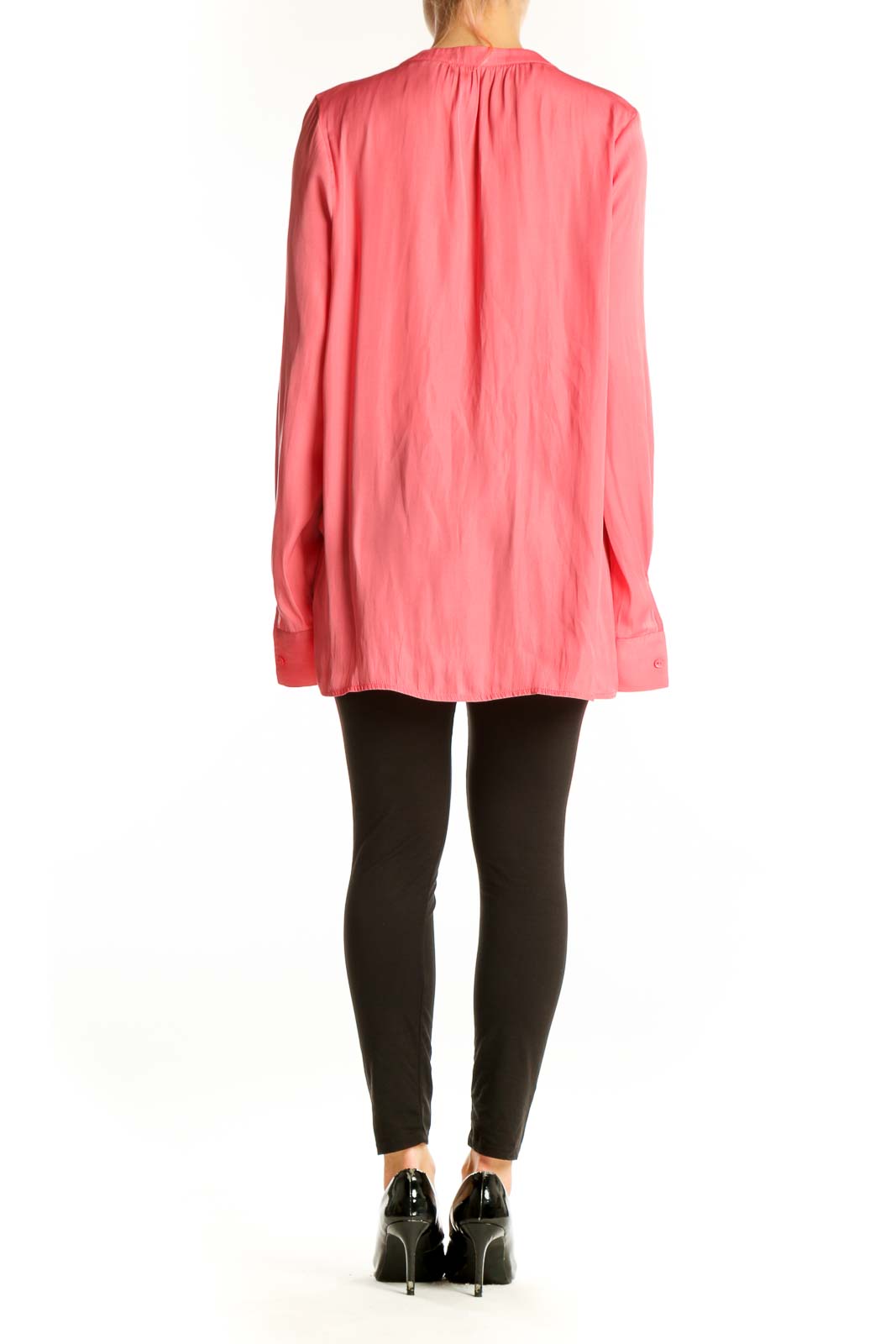 Side view of model wearing pink NYDJ long-sleeve polyester blouse with black pants