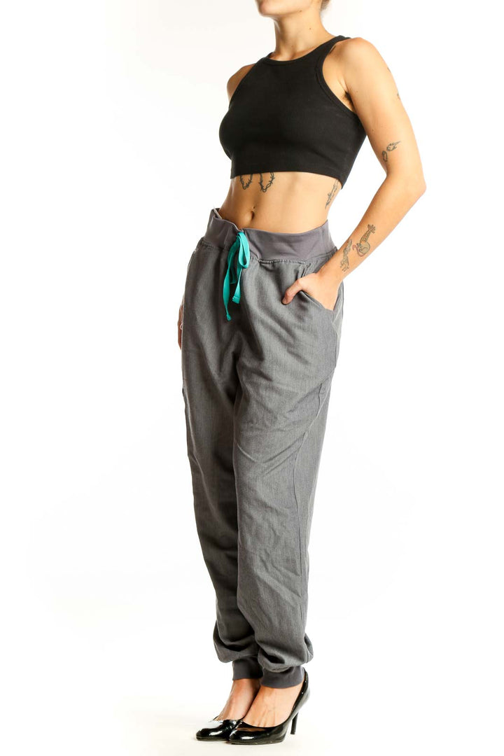 Front view of gray FIGS jogger pants with teal drawstring