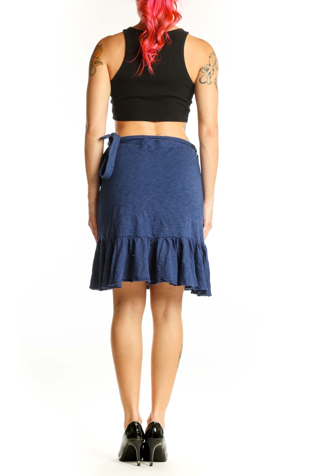 Back view of navy cotton mini skirt showing tiered ruffle design and asymmetrical hemline
