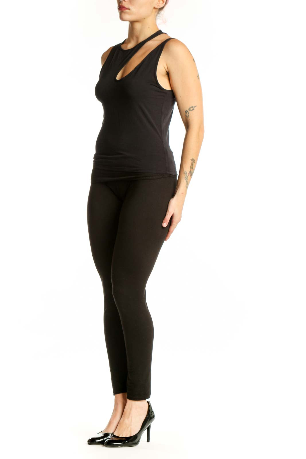 Black cutout tank top with asymmetrical neckline detail, front view on model