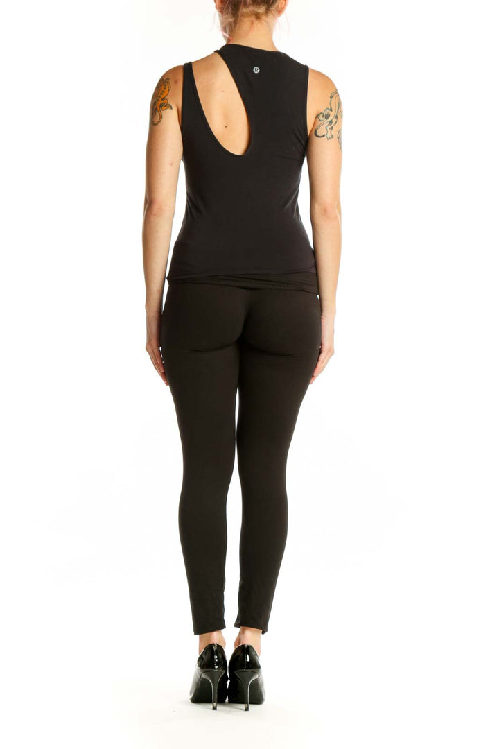 Black cutout tank top back view, showing sleeveless fitted design