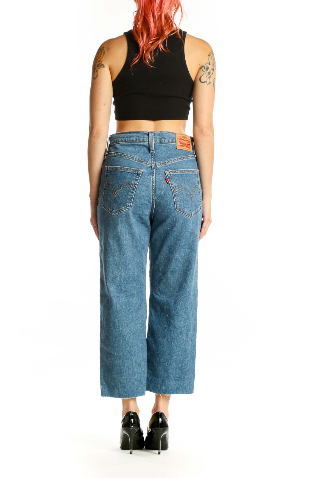 Side view of blue denim cropped wide-leg jeans showing fit and length on model