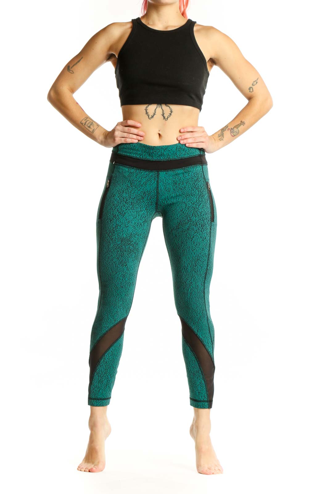 Front view of teal heathered Lululemon crop leggings with black mesh panel inserts and high-waisted design