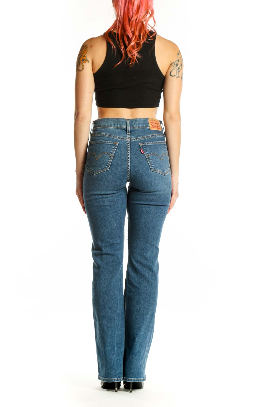 Back view of blue Levi's bootcut jeans on model, displaying bootcut silhouette and classic denim construction