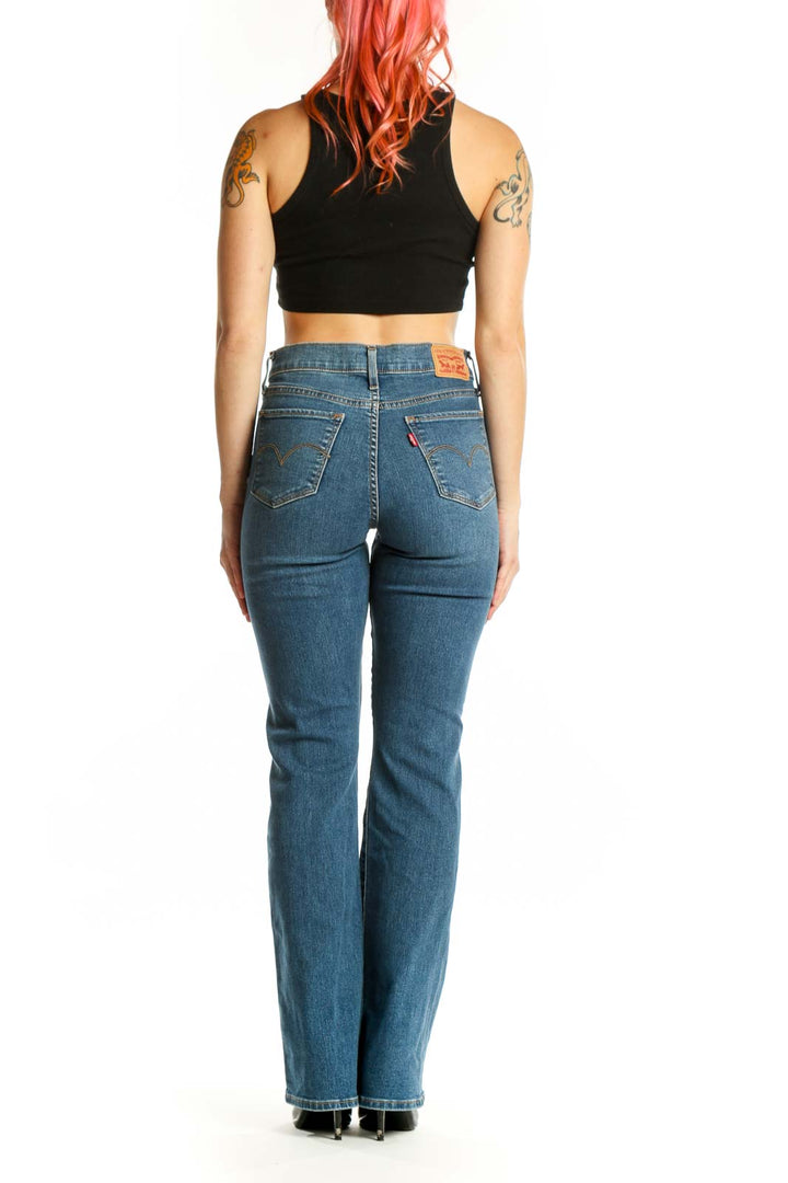 Back view of blue Levi's bootcut jeans on model, displaying bootcut silhouette and classic denim construction