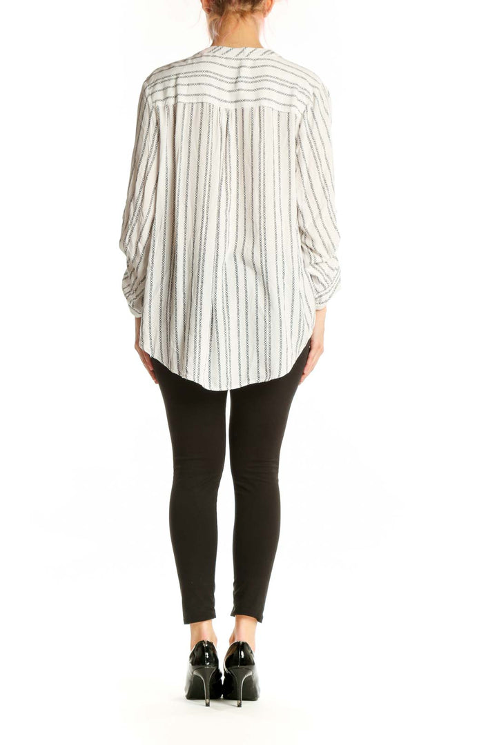 Cream and gray striped rayon button-up blouse with adjustable sleeves, back view