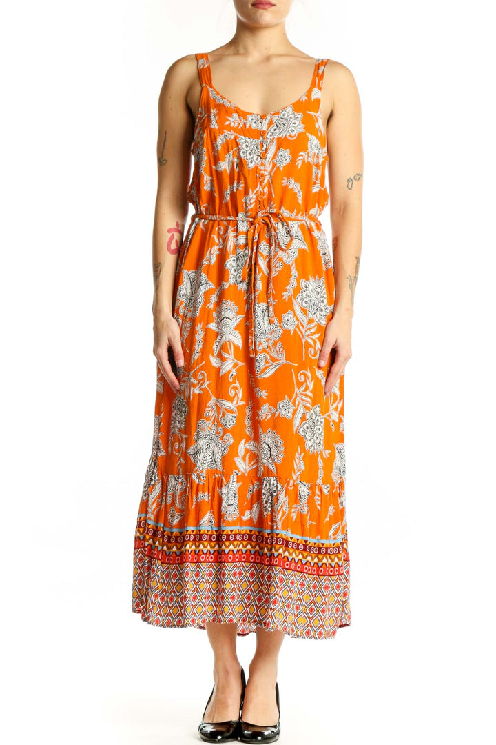Orange floral viscose midi dress with geometric patterned hem, front view on model