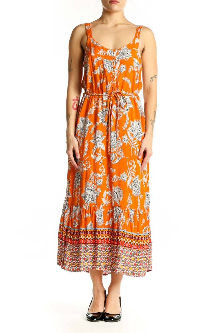 Orange floral viscose midi dress with geometric patterned hem, front view on model