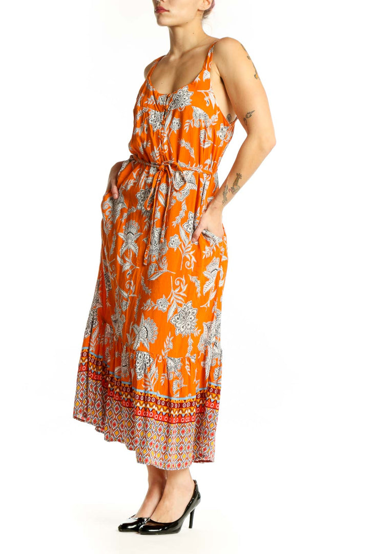 Orange floral viscose midi dress with geometric patterned hem, front view on model