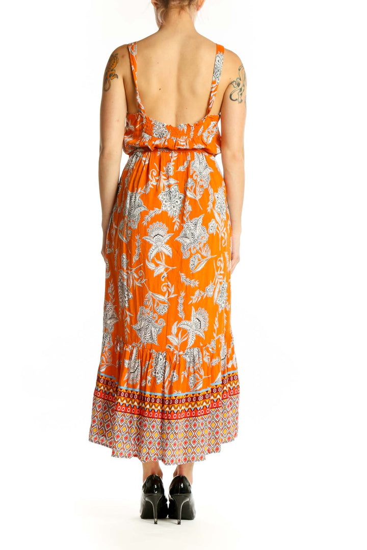 Orange floral viscose midi dress with drawstring waist and geometric border, back view on model