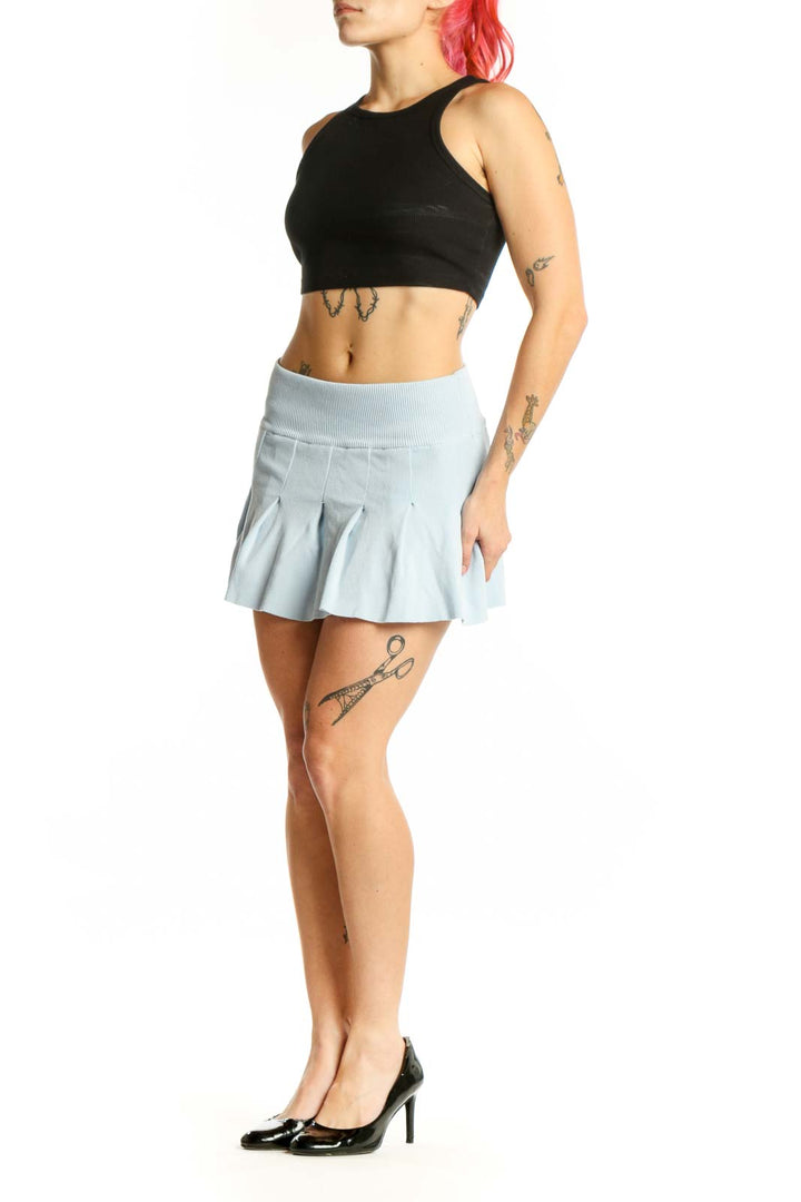 Light blue pleated mini skirt with A-line silhouette and ribbed waistband, front view