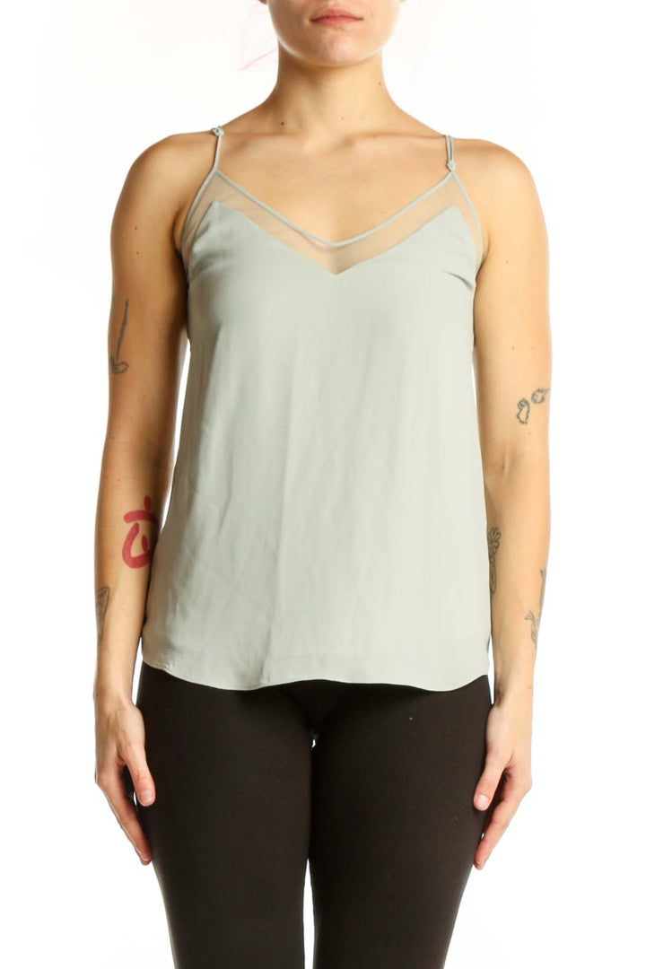 Cream camisole tank top with V-neckline and adjustable spaghetti straps, front view