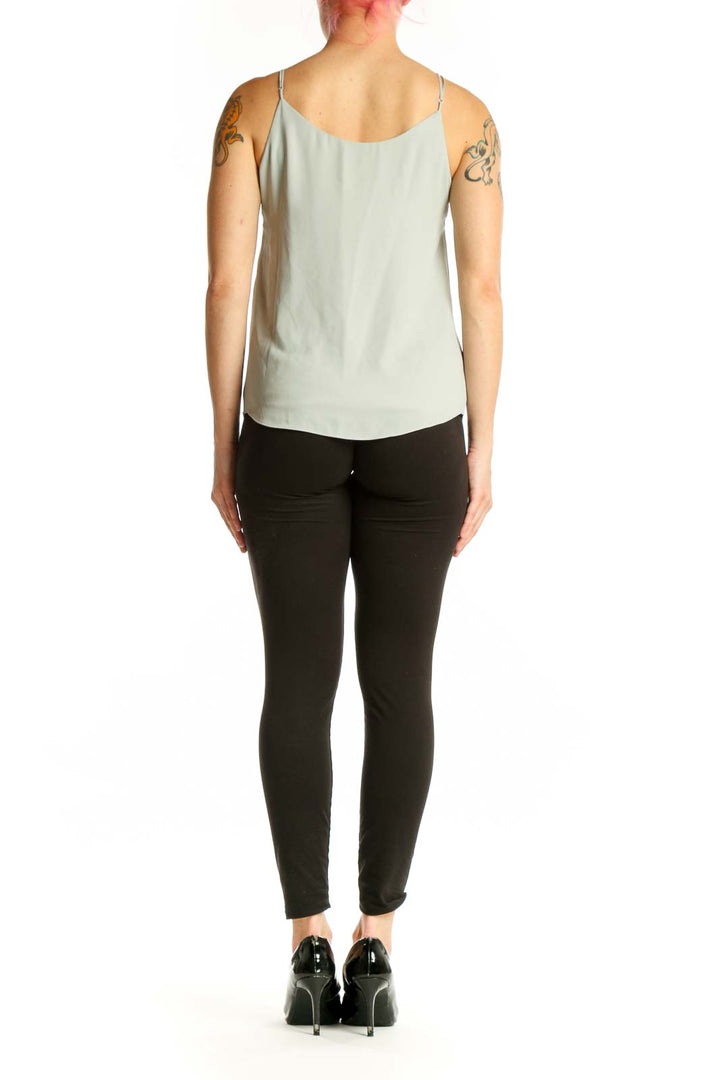 Cream camisole tank top with V-neckline and adjustable spaghetti straps, back view