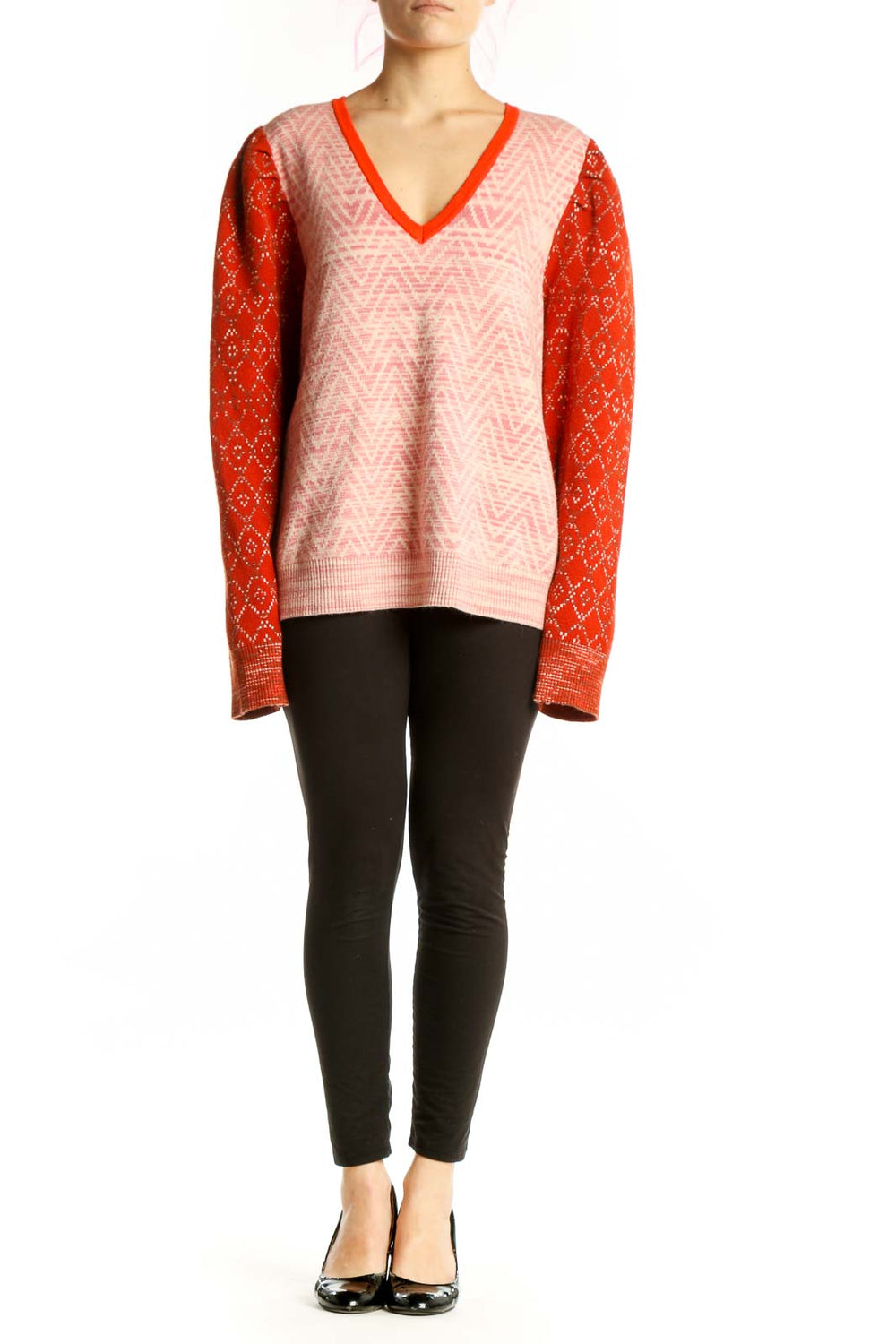 Red and pink colorblock knit sweater with V-neckline and geometric diamond pattern sleeves, front view