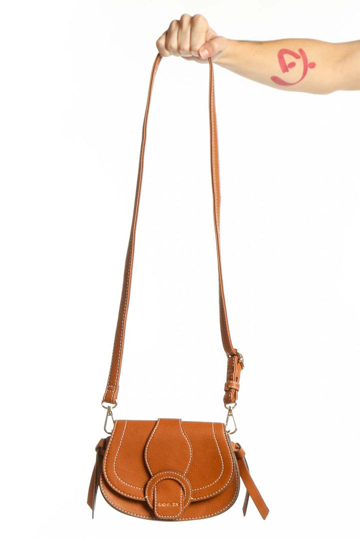 Cognac leather saddle crossbody bag by Rachel Zoe with white topstitching and adjustable leather straps, front view