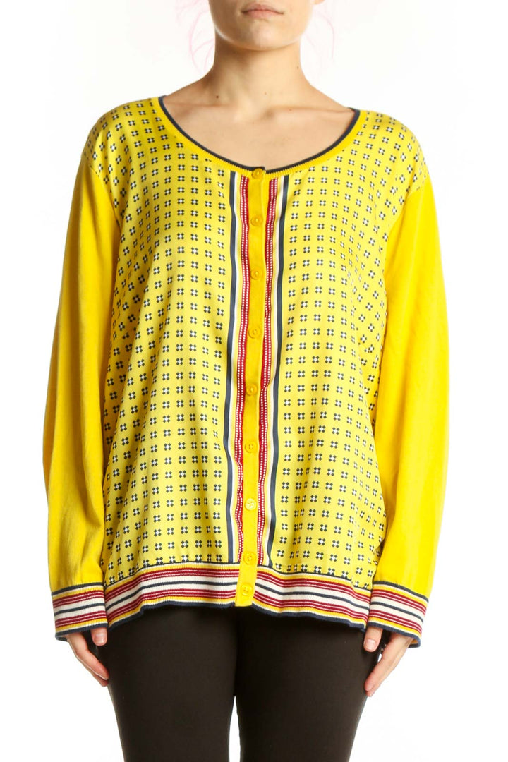 Yellow geometric print cardigan top with red and white striped trim, front view on model