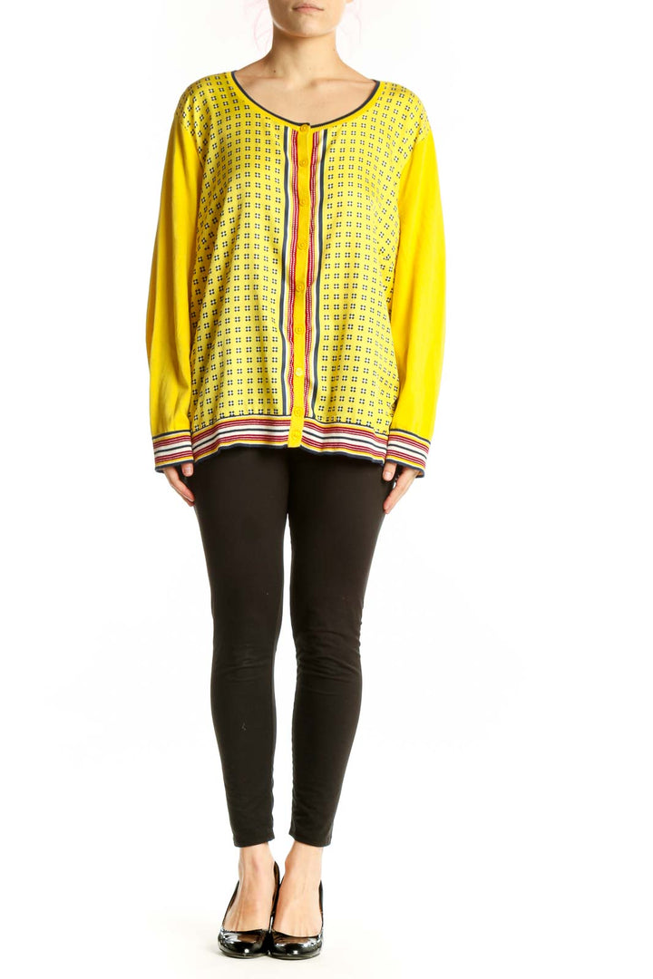 Yellow geometric print cardigan top with red and white striped trim, front view on model