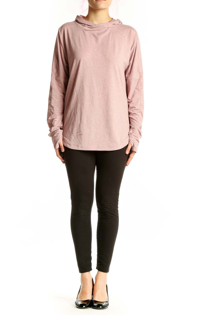 Pink hooded long sleeve activewear top by REI COOP, front view on model wearing black leggings
