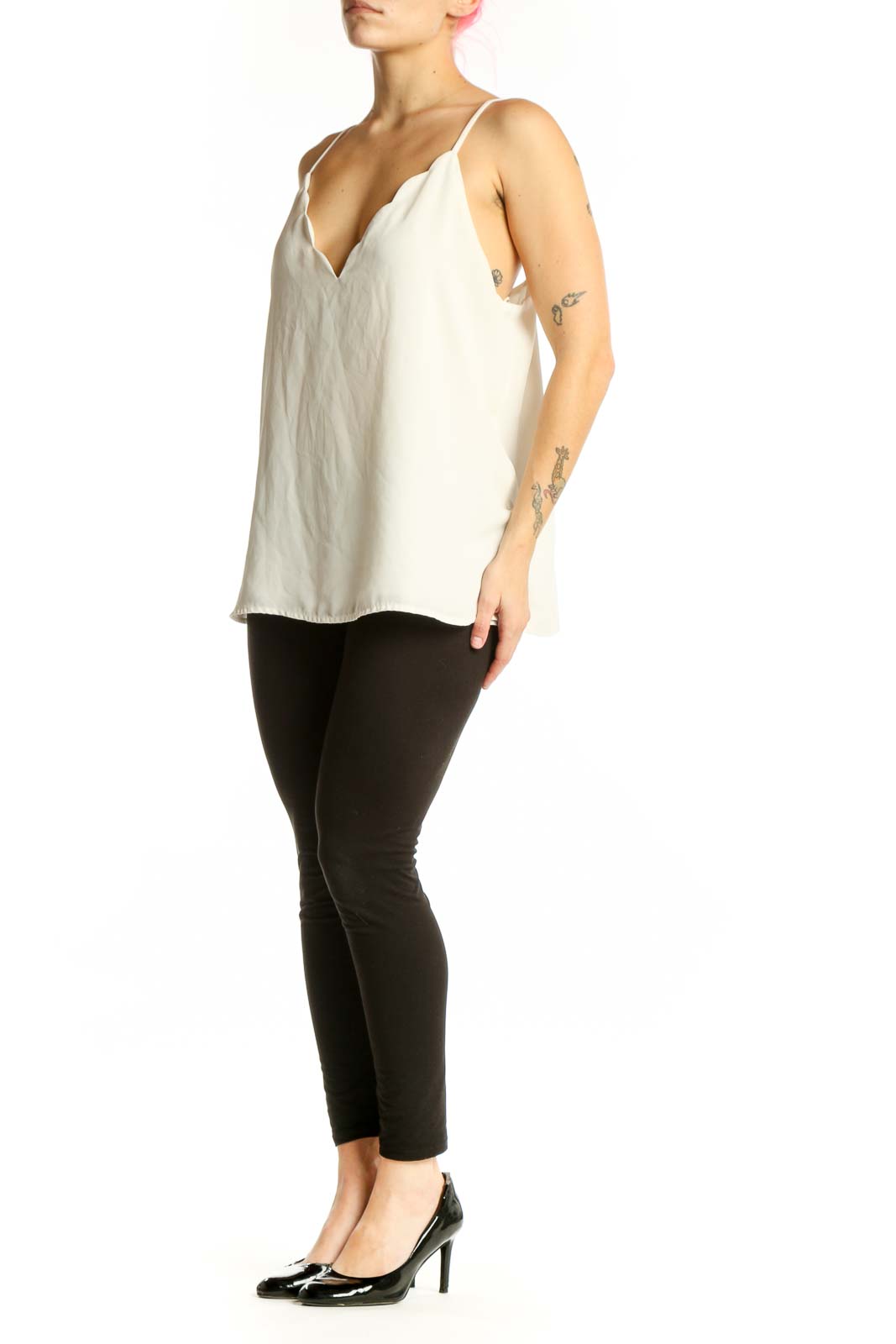 Cream V-neck camisole tank top with scalloped detailing and spaghetti straps, front view