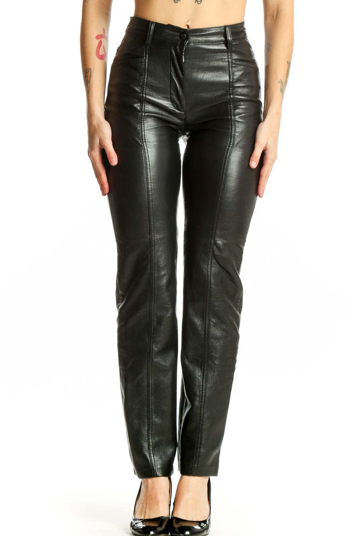 Black leather high-waisted slim fit pants by Wilfred, front view showing sleek silhouette and seam detailing