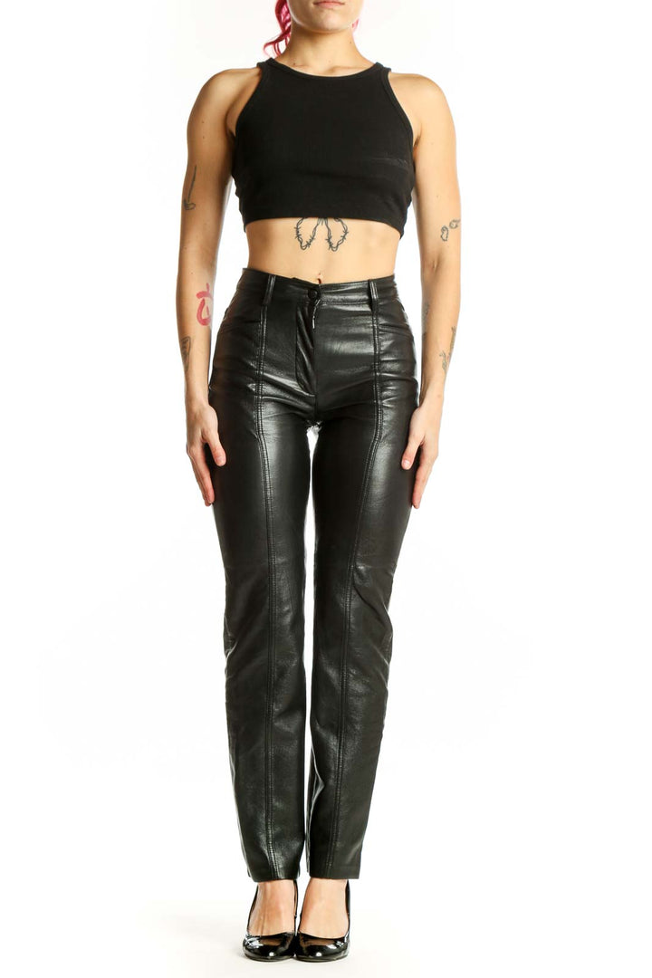 Black leather high-waisted slim fit pants by Wilfred, front view showing sleek silhouette and seam detailing