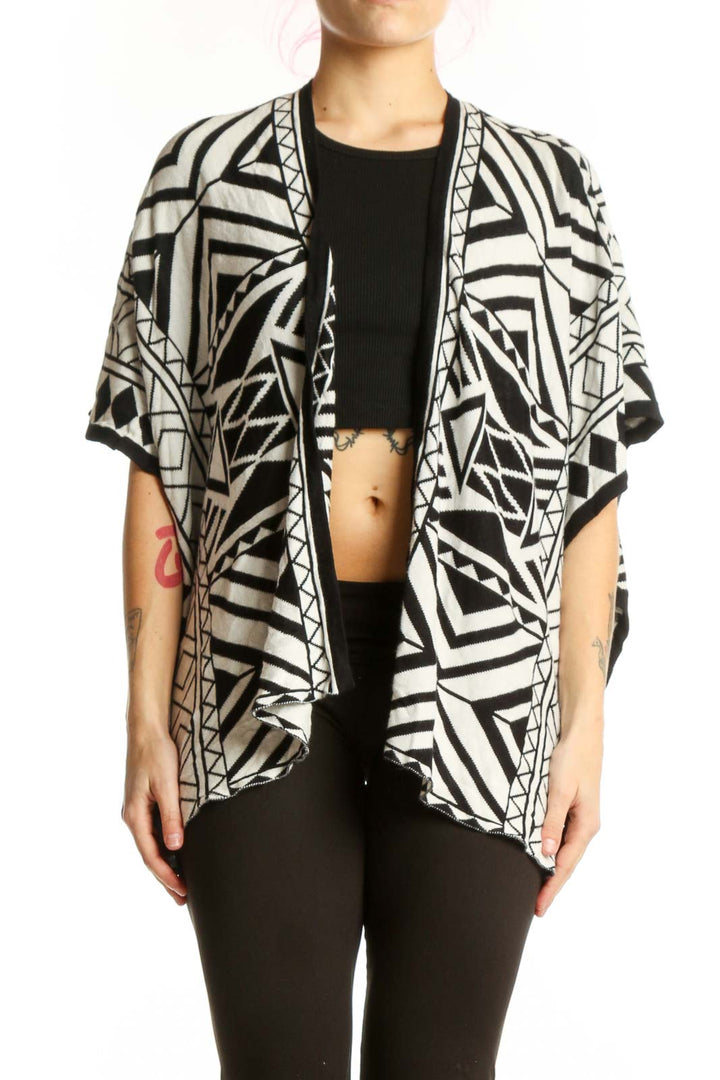 Black and white geometric kimono cardigan with abstract pattern, open front design, worn over black top
