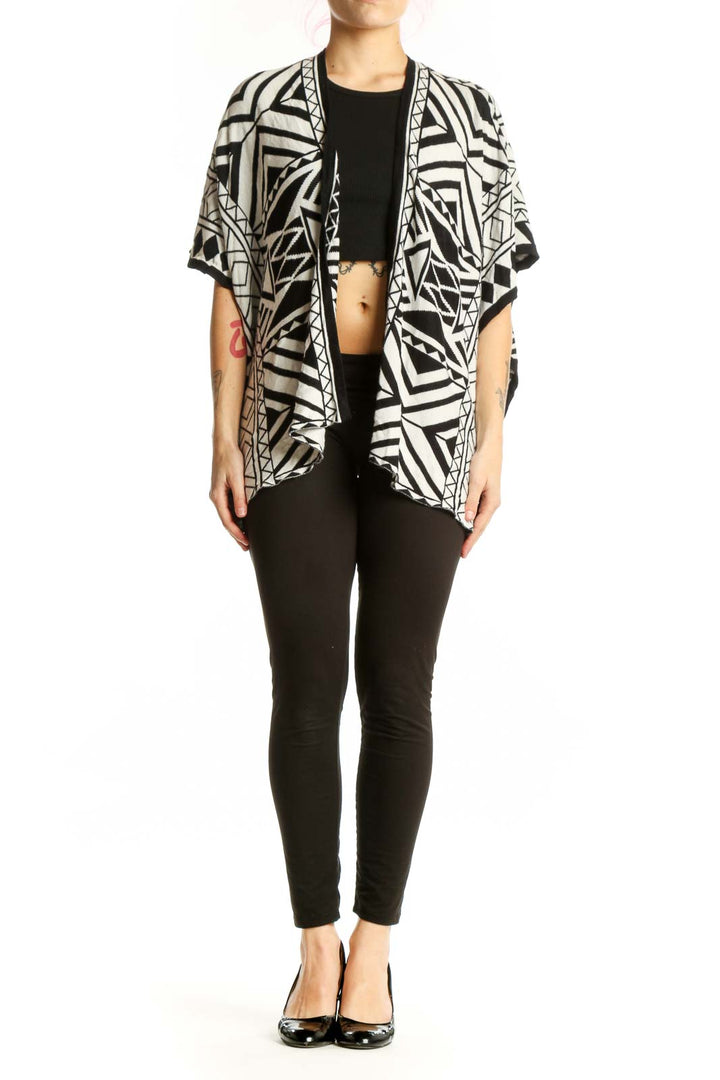 Black and white geometric kimono cardigan with abstract pattern, open front design, worn over black top