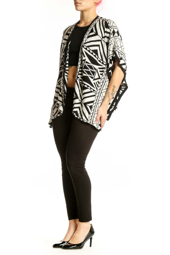 Black and white geometric kimono cardigan with abstract pattern, open front design, worn over black top