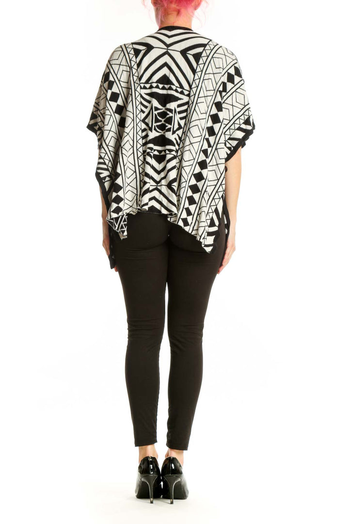 Back view of black and white geometric kimono cardigan showing full pattern and relaxed draping silhouette