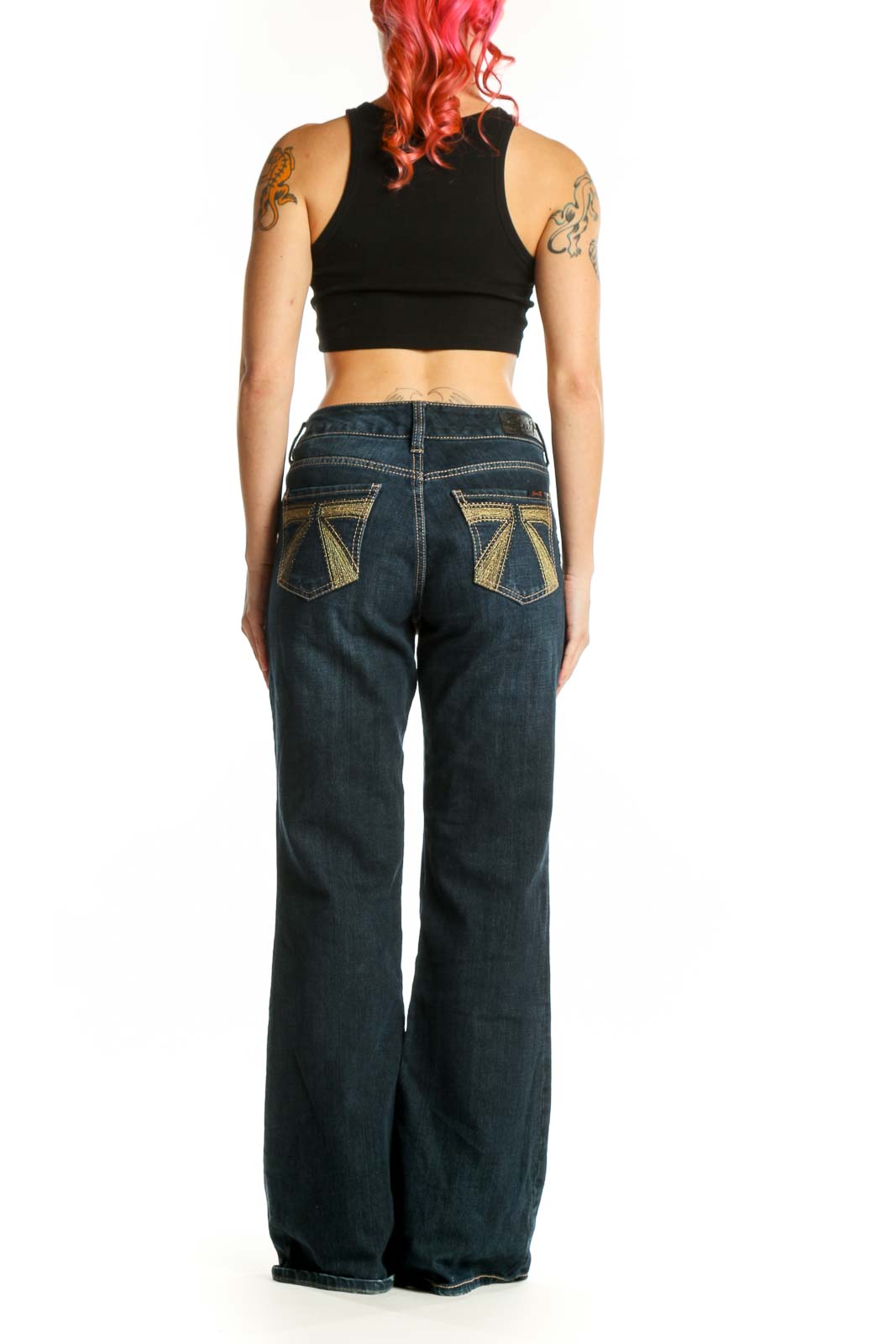 Back view of dark blue denim flare jeans showing the flare silhouette and fit