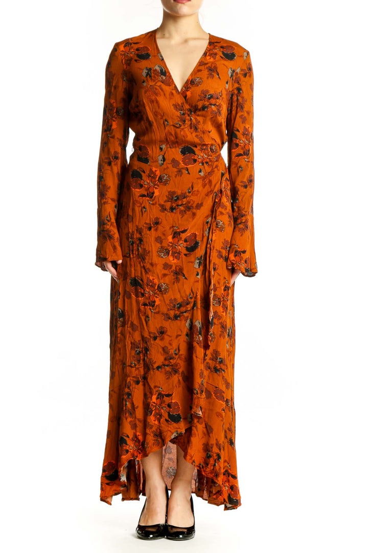 Front view of orange floral wrap dress with long sleeves and asymmetrical maxi hemline