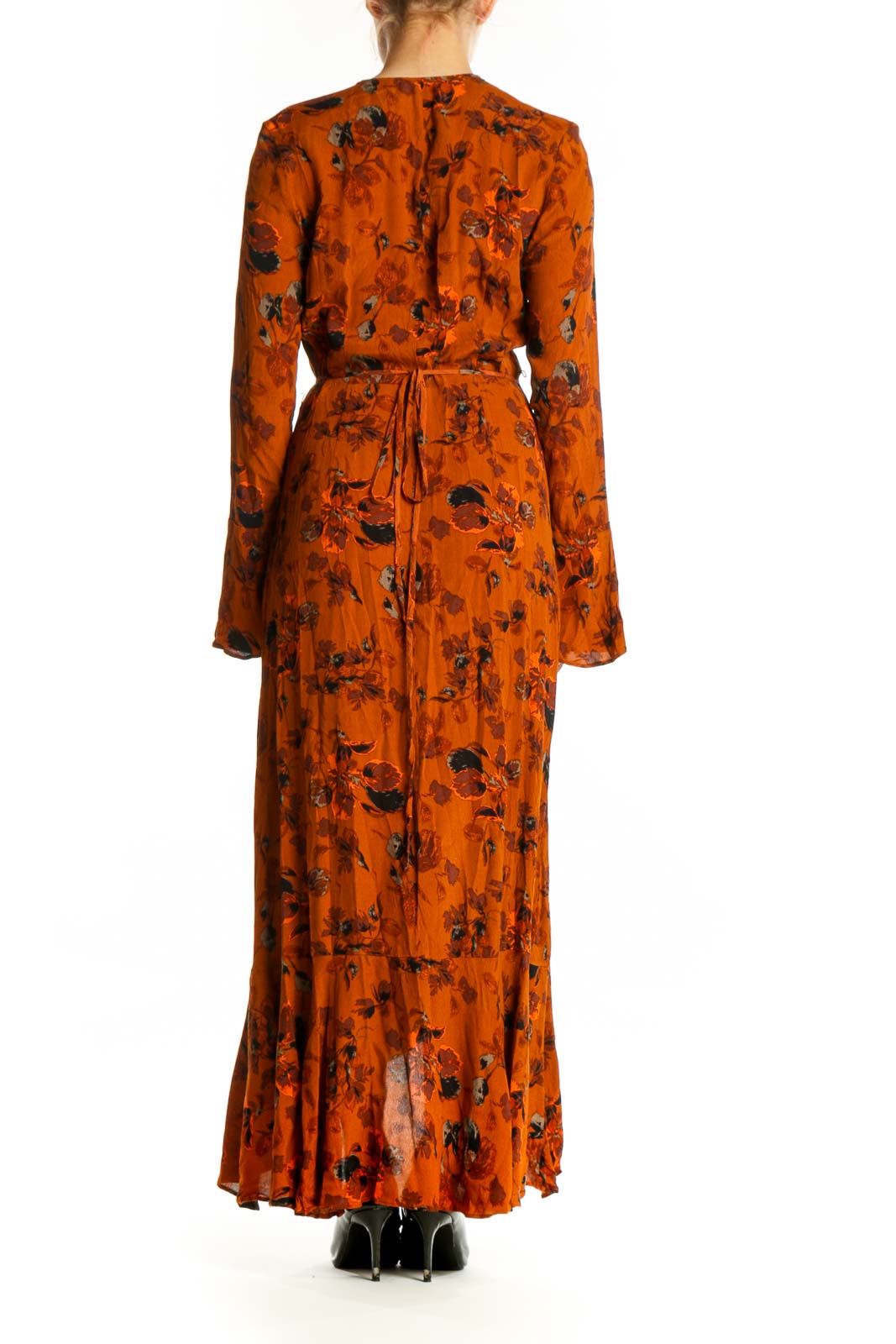 Back view of orange floral wrap dress showing draped rayon fabric and wrap-front design