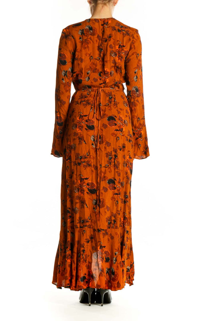 Back view of orange floral wrap dress showing draped rayon fabric and wrap-front design