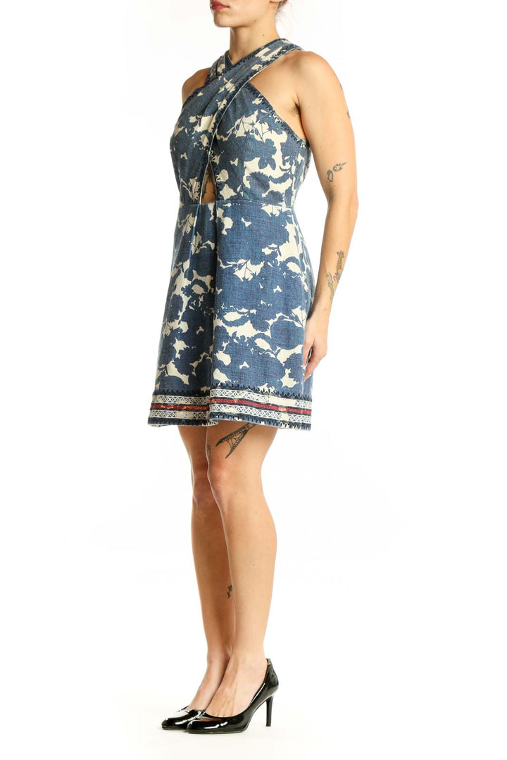 Navy floral halter dress with cream botanical print and cutout detail, front view