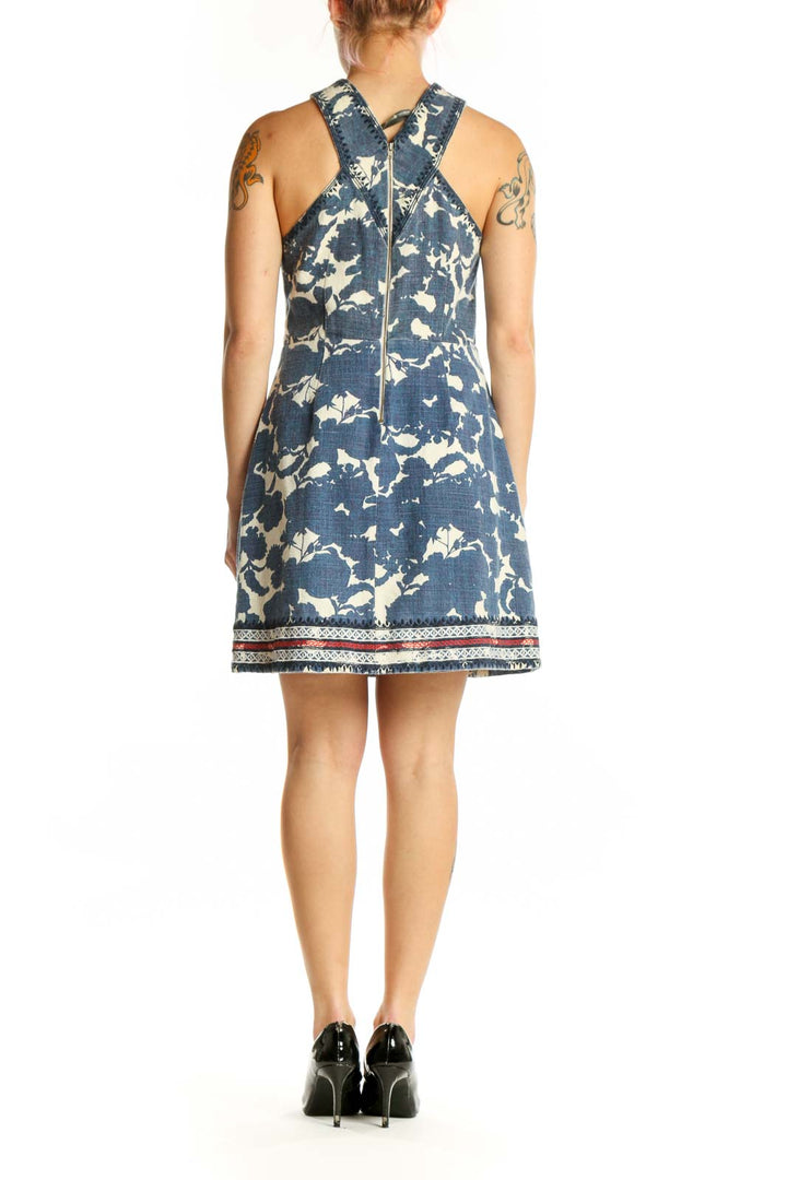 Navy floral halter dress with decorative trim and crossover back design, back view